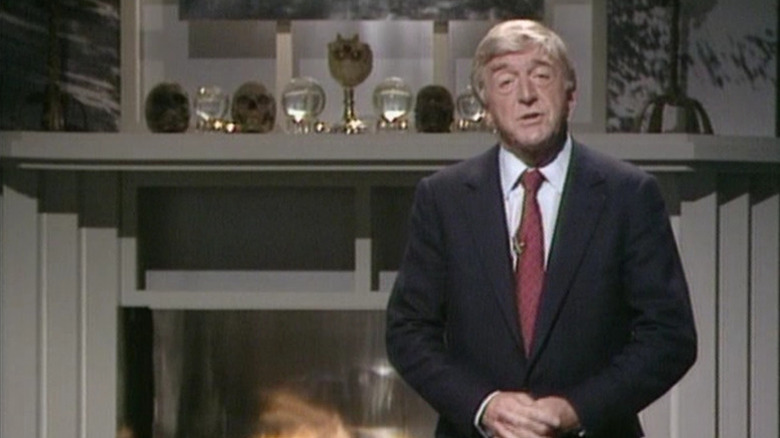 Michael Parkinson speaks to the audience from a fireplace set in Ghostwatch