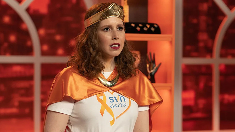 Vanessa Bayer as Joanna dressed as Wonder Woman in a Saving Cares shirt in I Love That For You