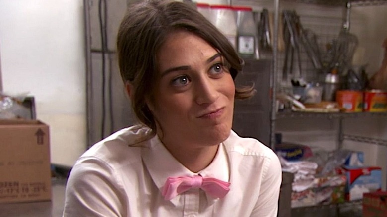 Lizzy Caplan as Casey in her caterer uniform smiling in Party Down