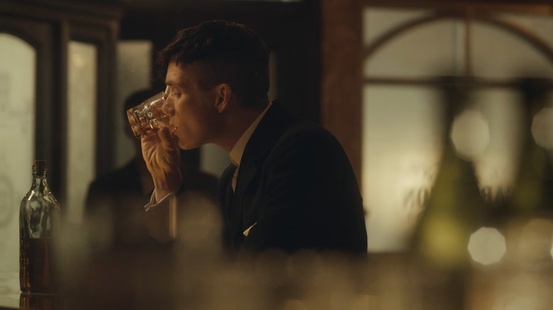 Tommy Shelby (Cillian Murphy) drinking in Peaky Blinders