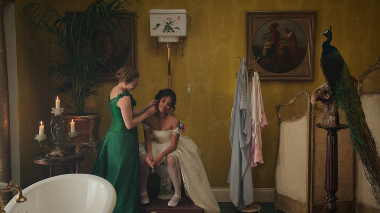 Nan (Kristine Froseth) putting on Conchita's (Alisha Boe) earring in The Buccaneers
