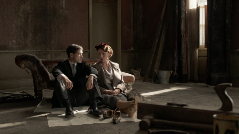 Hallam (Ed Stoppard) and Agnes (Keeley Hawes) sitting on floor in derelict manor house in Upstairs, Downstairs