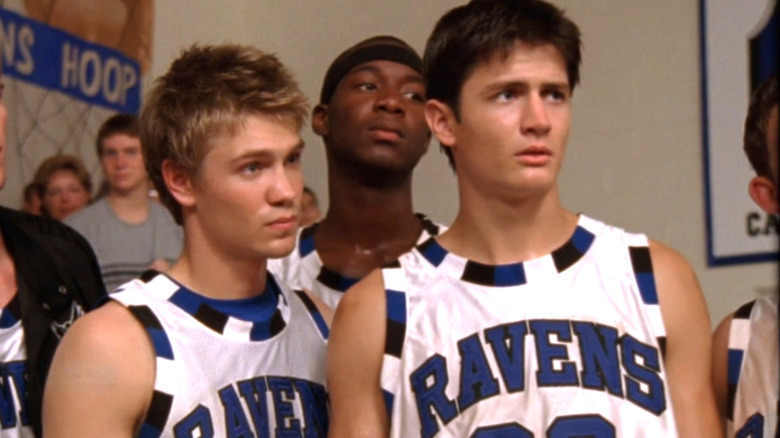 Chad Michael Murray as Lucas Scott stands on the basketball court next to James Lafferty as Nathan Scott in One Tree HIll