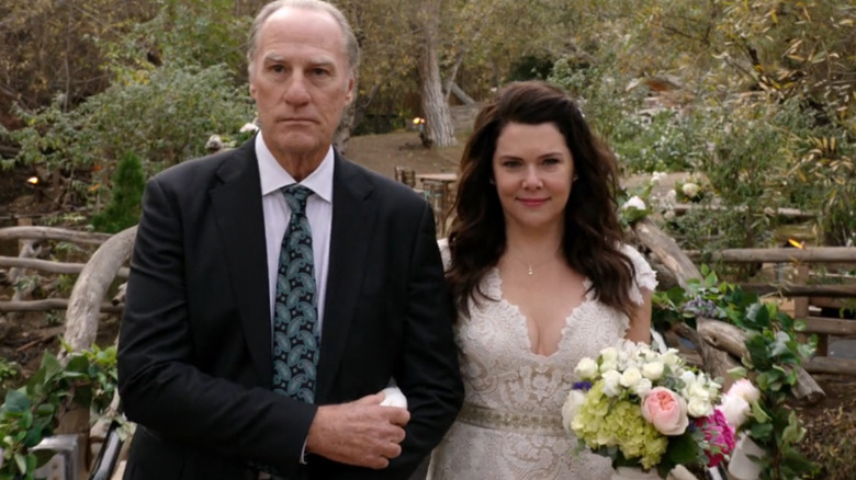 Craig T. Nelson as Zeek Braverman walks next to Lauren Graham as Sarah Braverman in a wedding dress in Parenthood