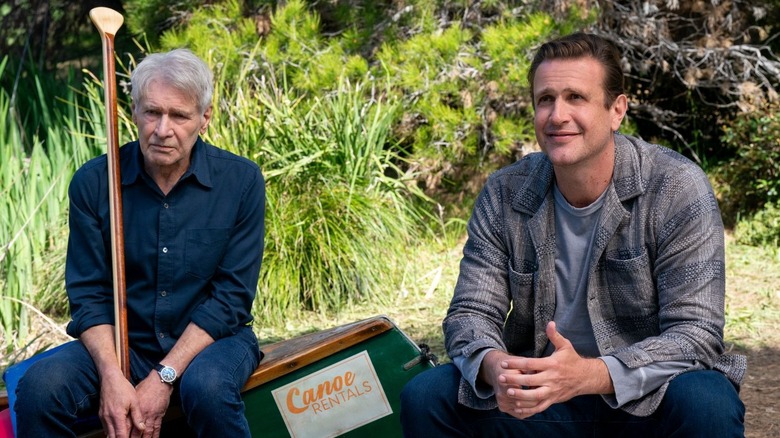 Harrison Ford as Paul sits on a canoe next to Jason Segel as Jimmy in Shrinking