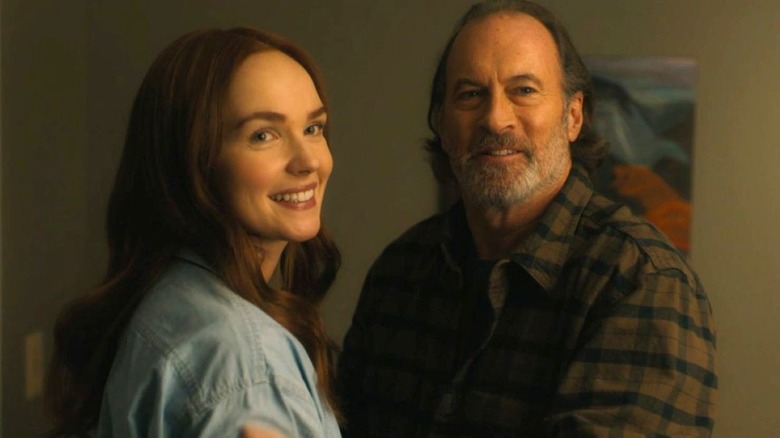 Morgan Kohan as Maggie Sullivan smiles while standing next to Scott Patterson as Sully in Sullivan's Crossing