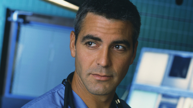 George Clooney as Doug Ross, standing in an operating theater on E.R.