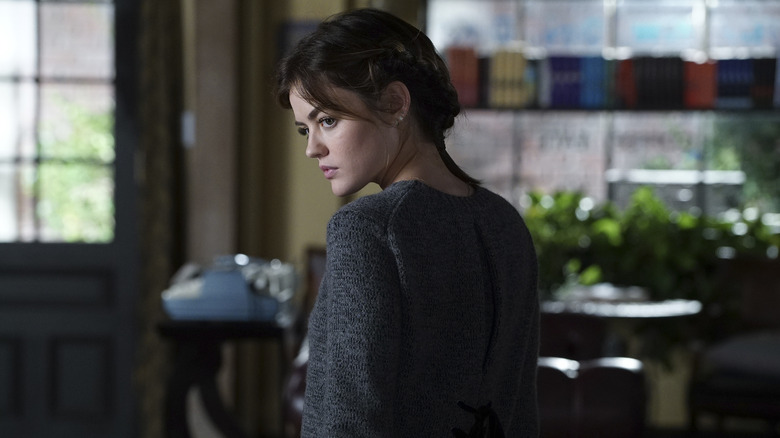 Lucy Hale as Aria, looking over her shoulder in Pretty Little Liars