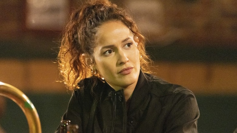 Jaina Lee Ortiz as Andy Hererra, sitting at a bar on Station 19