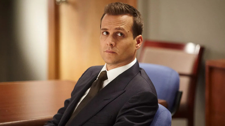 Gabriel Macht as Harvey Specter, leaning back in a chair on Suits
