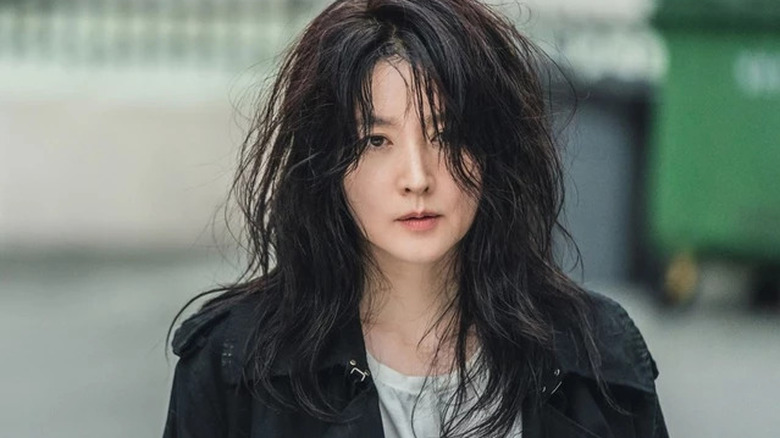 Lee Young-ae as Koo Kyung Yi standing in street with messy hair in Inspector Koo