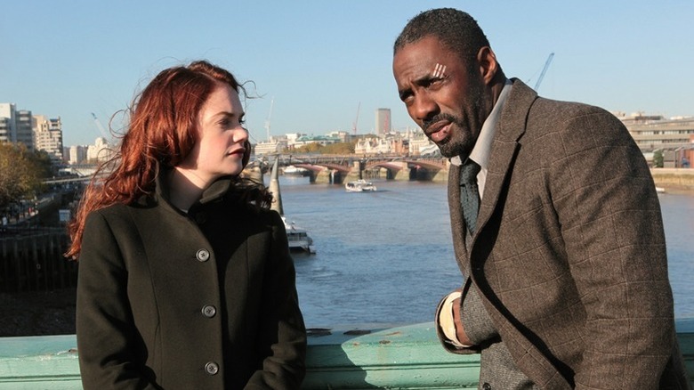 Ruth Wilson as Alice Morgan standing on a bridge next to Idris Elba as DCI John Luther in Luther