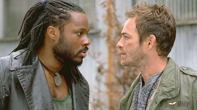 Jaremiah (Luke Perry) and Kurdy (Malcolm-Jamal Warner) stare intensely at each other in Jeremiah