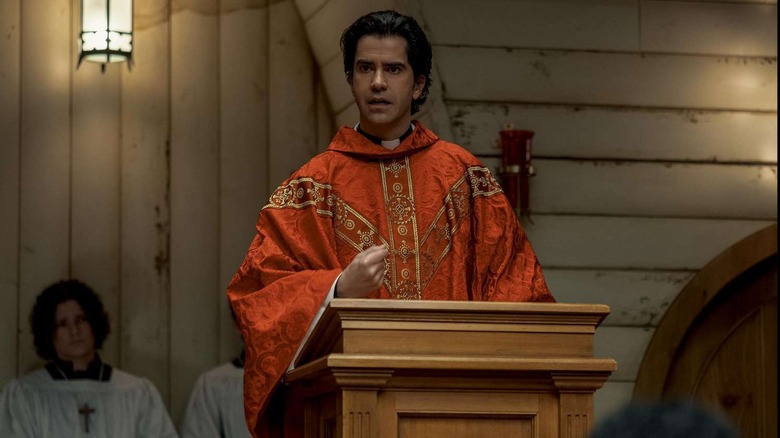 Hamish Linklater is a small town priest at the pulpit in Midnight Mass