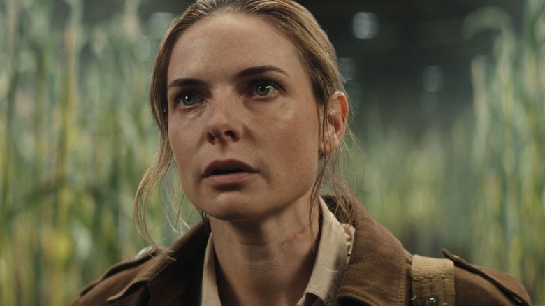 Rebecca Ferguson, as Juliette, stands among corn in Silo