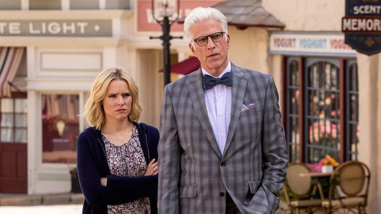 Ted Danson (Michael) and Eleanor (Kirsten Bell) stand on an old timey street in The Good Place