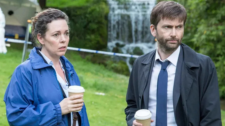 Ellie Miller (Olivia Colman) and Alec Hardy (David Tennant) hold coffee at a crime scene in Broadchurch