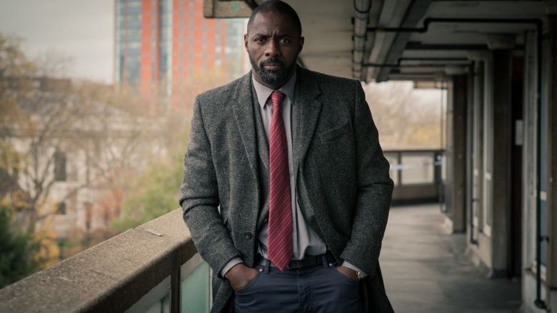 John Luther (Idris Elba) walks stoically along a railing in Luther