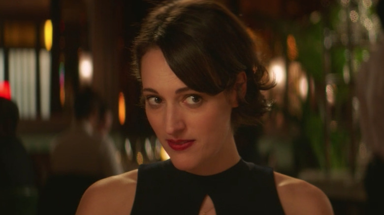 Phoebe Waller-Bridge as Fleabag side-eyeing someone at dinner in Fleabag