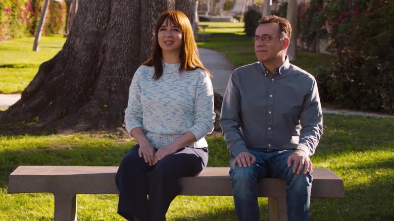 Maya Rudolph and Fred Armisen as June and Oscar sitting on a bench together in Forever