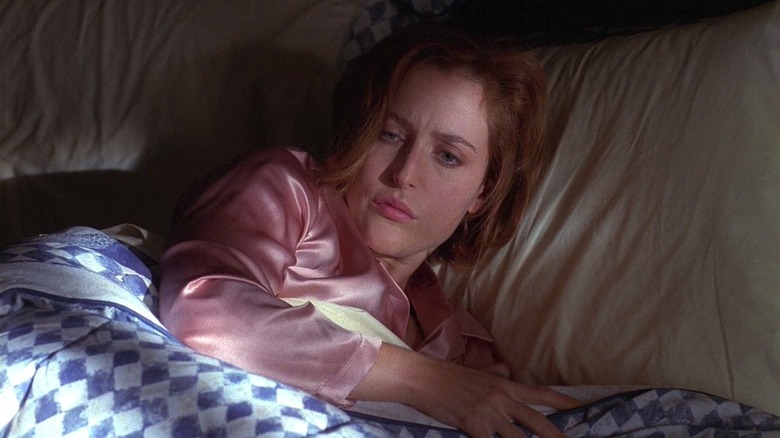 Gillian Anderson as Dana Sculley waking up in bed in The X-Files