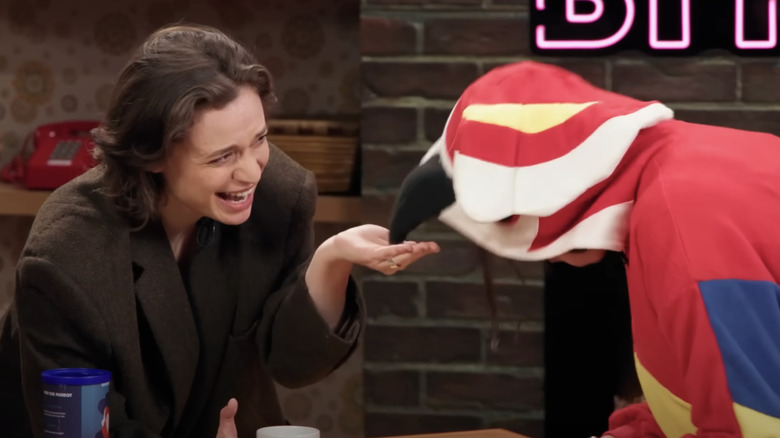 Angela Giarratana laughing as Amanda Lehan-Canto as a parrot eats from her palm in Bit City