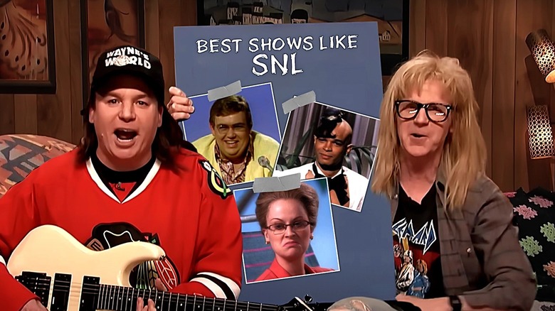 Mike Myers and Dana Carvey as Wayne and Garth holding up a Best Shows Like SNL list with John Candy, Damon Wayans, and Amy Poehler on it