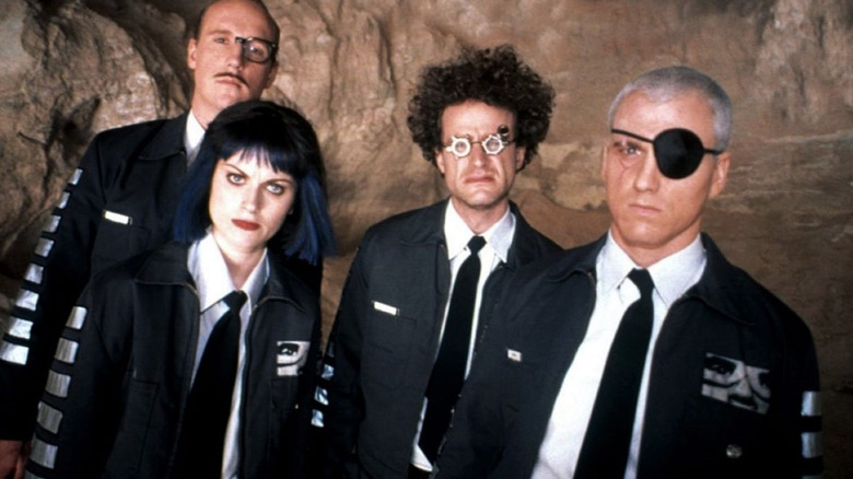 The cast of Upright Citizens Bridgade in matching jackets and villainous looks