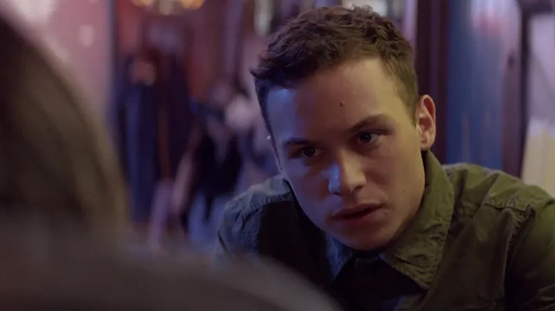 Joshua Cody (Finn Cole) looks questioningly in a dimly lit room in Animal Kingdom