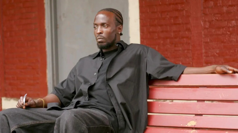 Omar Little (Michael K. Williams) sits contemplatively on a bench in The Wire