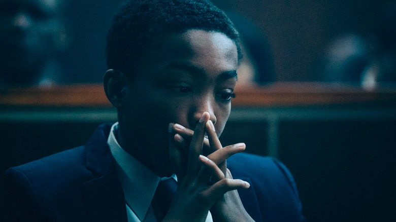 Kevin Richardson (Asante Blackk) sits in a courtroom with his hands over his mouth in When They See Us
