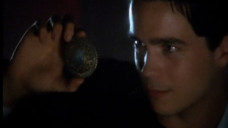 Vaughn Parrish (Kett Turton) staring at amulet in Dead Last