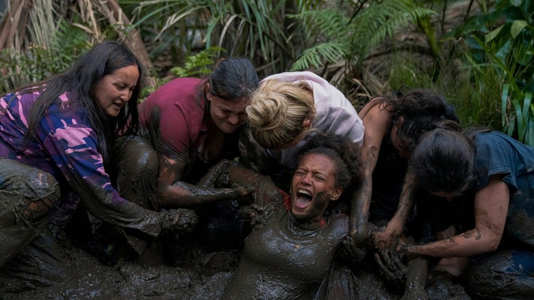 The survivors pull Rachel Reid (Reign Edwards) from deep mud in The Wilds