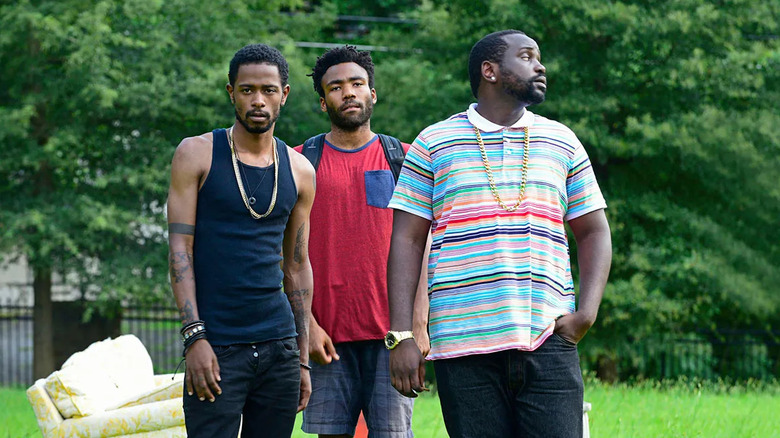 LaKeith Stanfield, Donald Glover, and Brian Tyree Henry as Darius, Earn, and Al, walking through grass on Atlanta