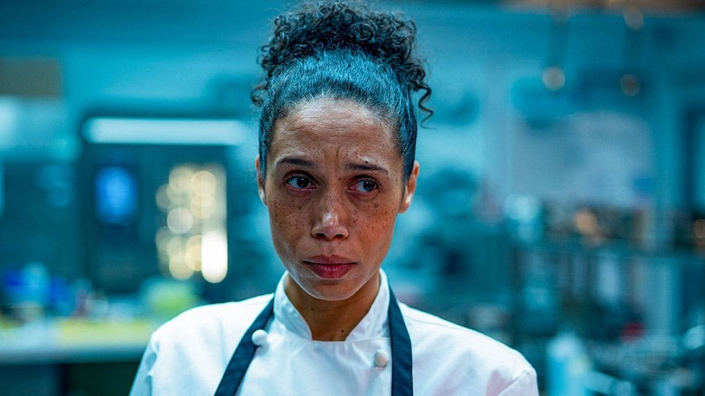 Vinette Robinson as Carly, looking worried in a kitchen in Boiling Point