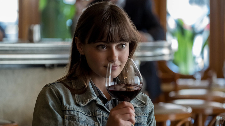 Ella Purnell as Tess, sniffing wine in Sweetbitter