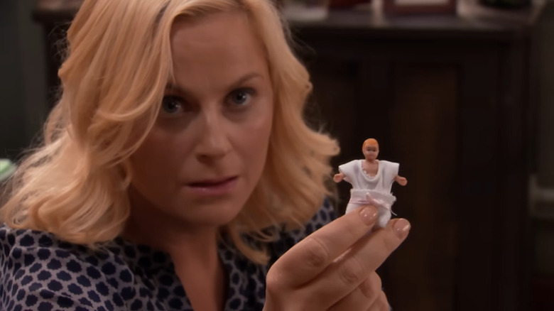 Leslie Knope (Amy Poehler) holding up a figurine on Parks and Recreation