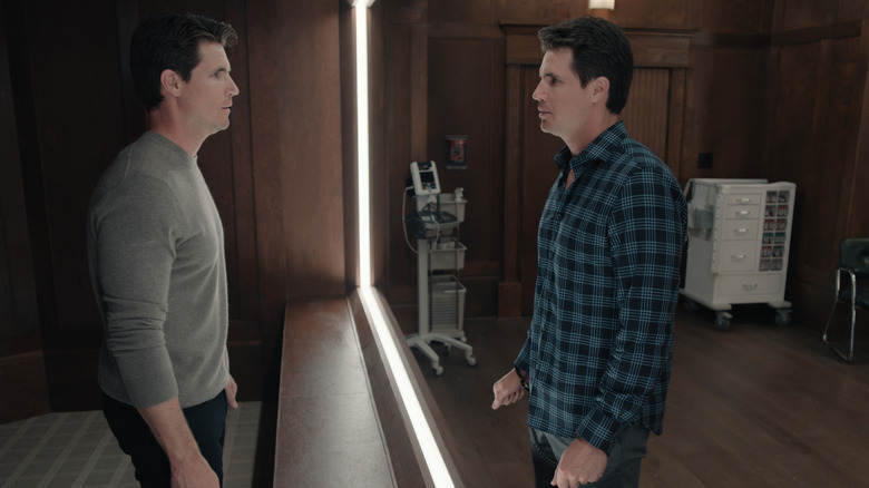 Nathan Brown (Robbie Amell) looking in a mirror on Upload