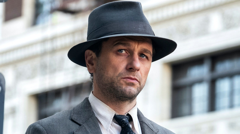 Matthew Rhys as Perry Mason, walking through the street in Perry Mason