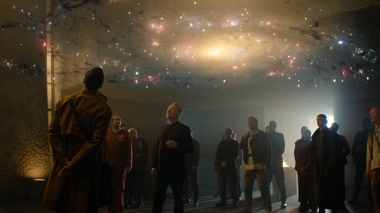 Hari Seldon and a group looking at a map of the galaxy in Foundation season 3