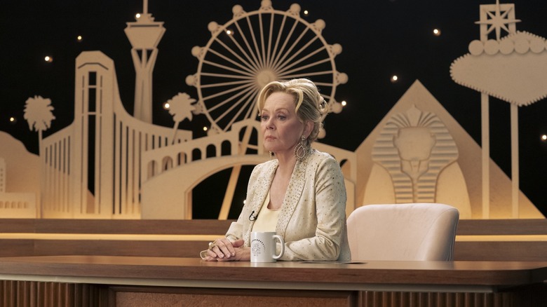Jean Smart as Deborah Vance sitting at the desk on her late night show on Hacks season 4