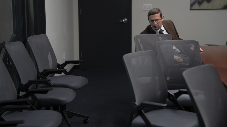 Ron in a conference room looking at a bunch of chairs on The Chair Company