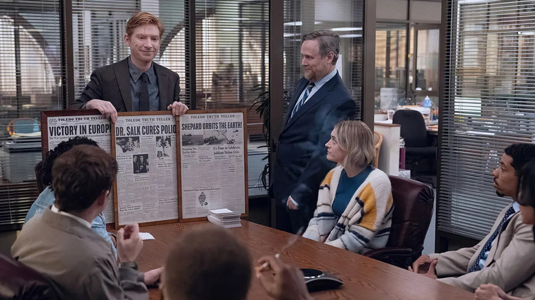 Ned shows his team a framed newspaper in The Paper