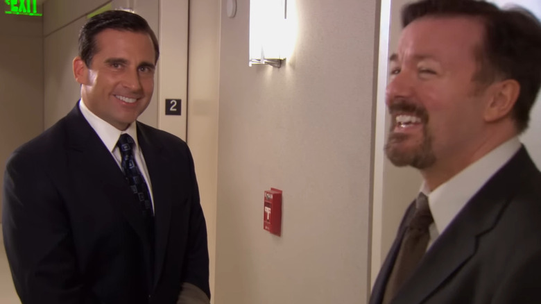 Steve Carrell and Ricky Gervais as Michael Scott and David Brent, laughing together on The Office.