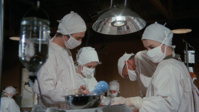 Surgical team operating on MASH