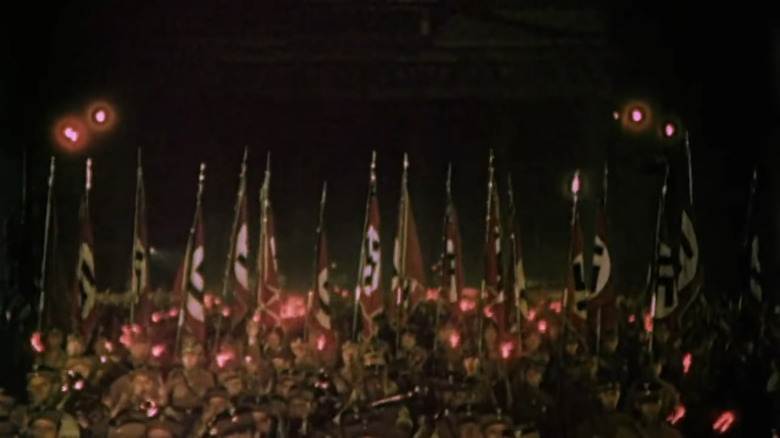 Documentary footage of Nazis marching with swastika flags