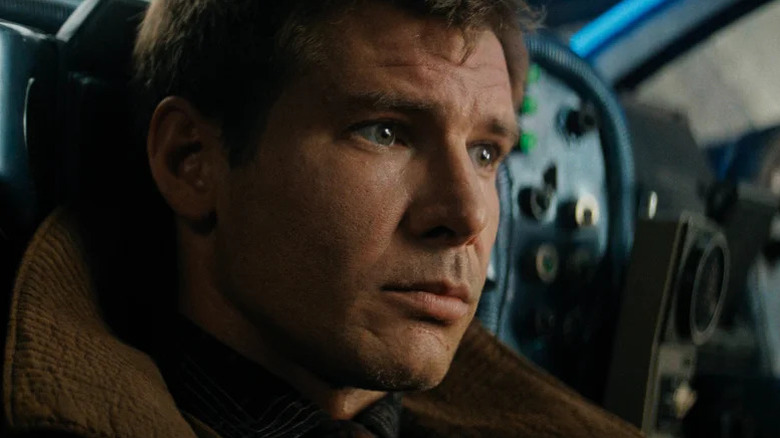 Rick Deckard (Harrison Ford) stares pensively in his car in Blade Runner