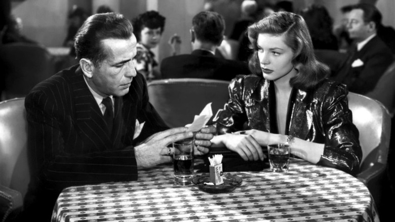 Philip Marlowe (Humphrey Bogart) and Vivian Rutledge (Lauren Bacall) at dinner in The Big Sleep (1946)