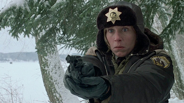 Frances McDormand as Marge holding her gun in the snow in Fargo