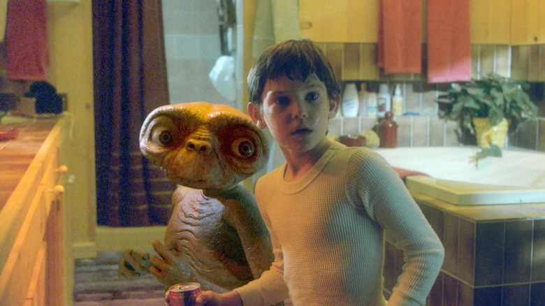 Henry Thomas as Elliott Taylor in E.T.: The Extra-Terrestrial, standing sweaty and anxious in a bathroom next to E.T., looking the same direction.